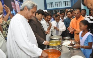Dignitaries And Bystanders Celebrate As First Mid Day Meals Are Served